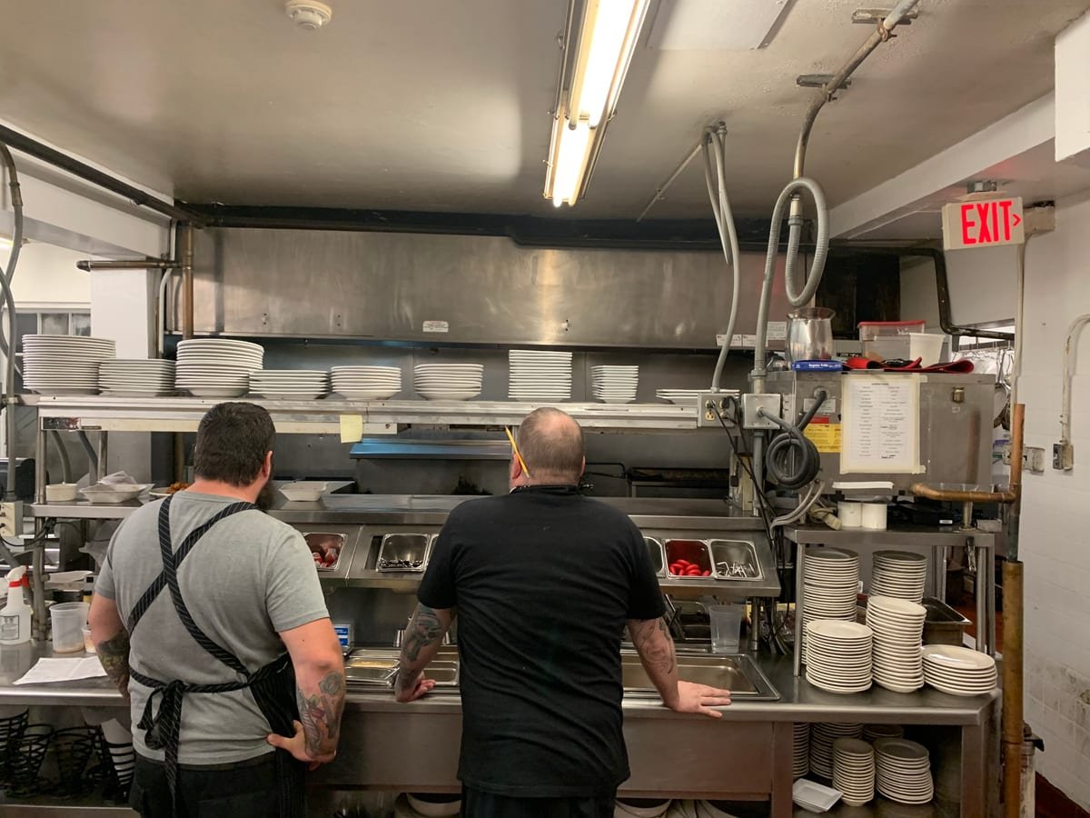 Clean commercial kitchen line, stainless steel and prep surfaces